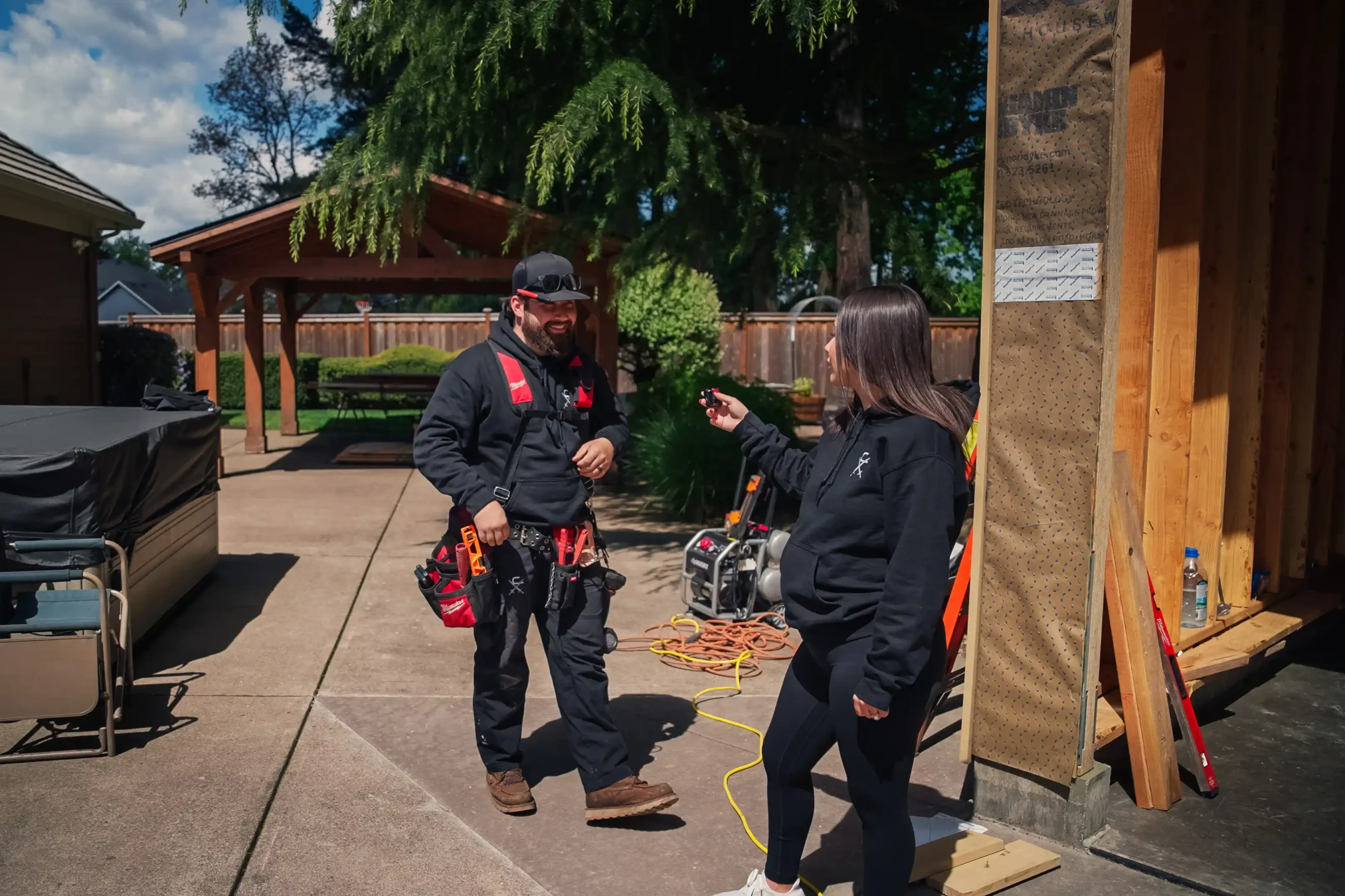 Clark Exteriors team discussing a homeowner project